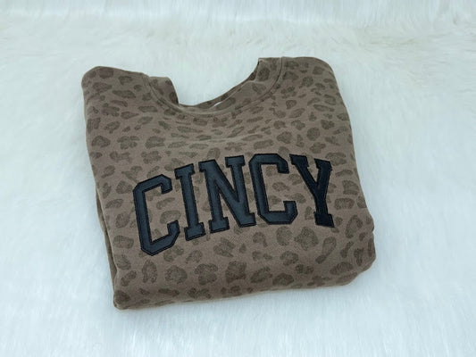 Leopard print pouch with 'Cincy' text on a white background